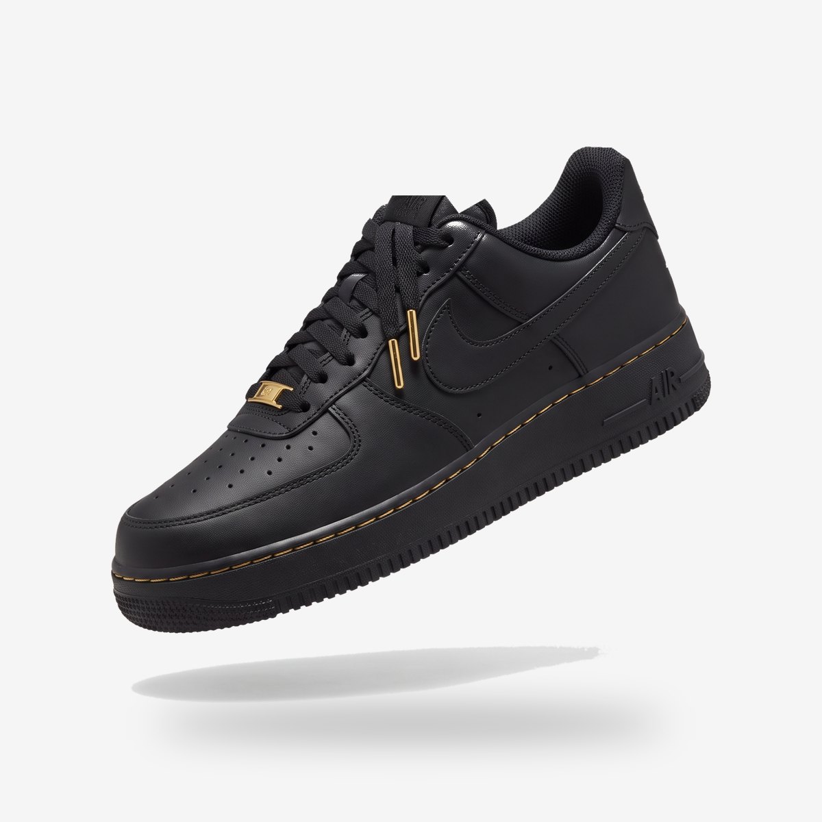 Black Air Force 1 with gold lace tips and gold stitch